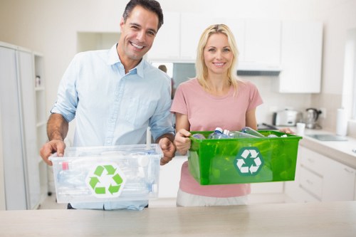 Workers sorting commercial recyclables into bags and bins